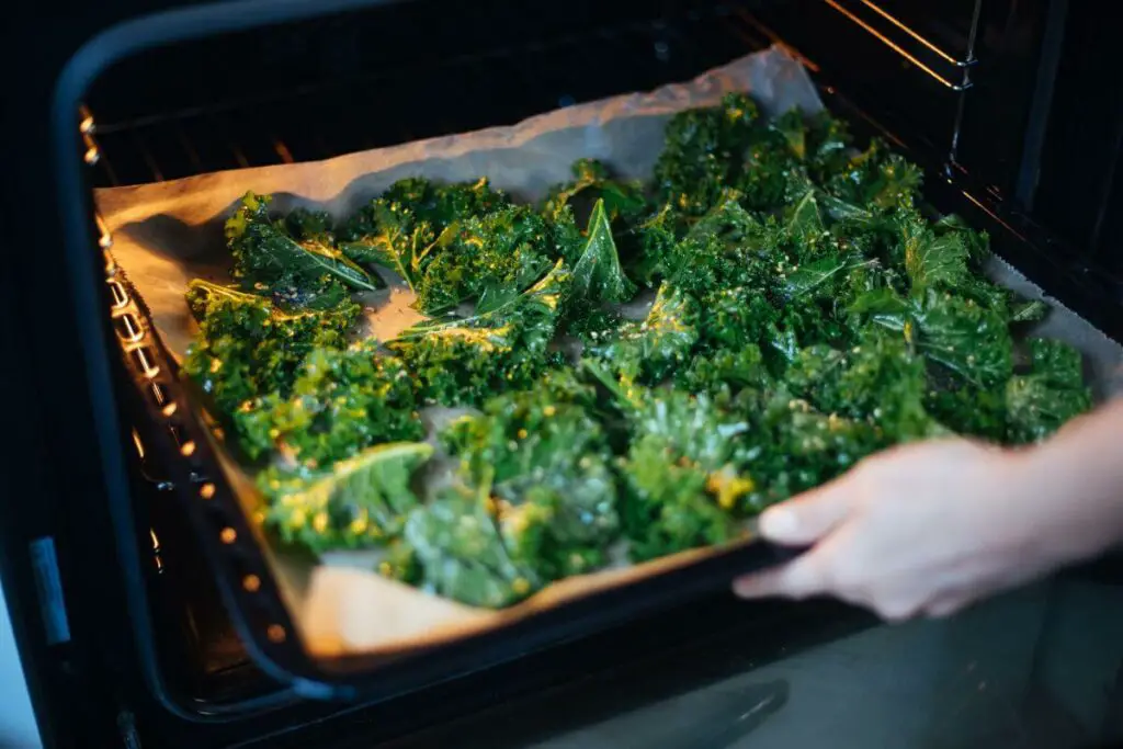 A person baking kale for their IBS diet.