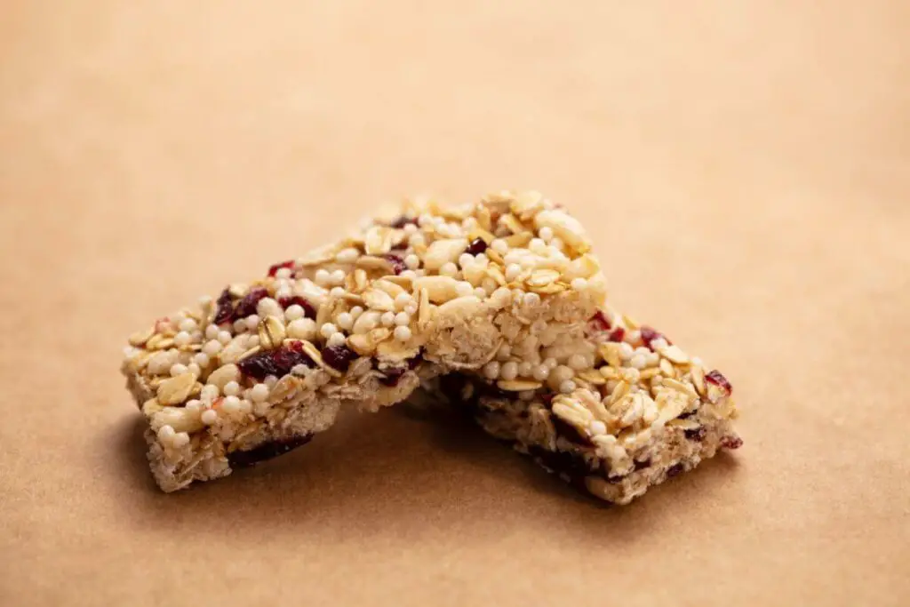Healthy cranberry granola bars on a brown background.