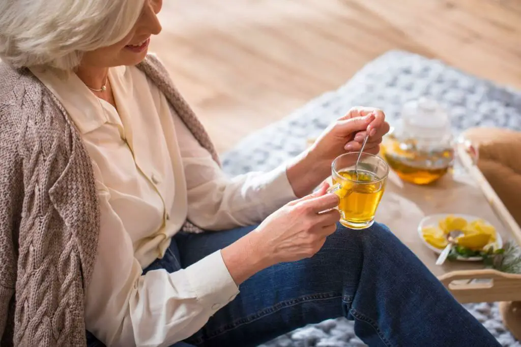 Keywords used: cup of tea

Description: A woman is sitting on a rug, enjoying a soothing cup of tea.
