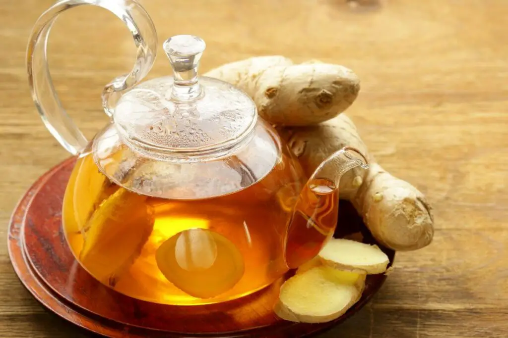 Ginger tea, one of the best drinks for IBS, placed on a wooden table.