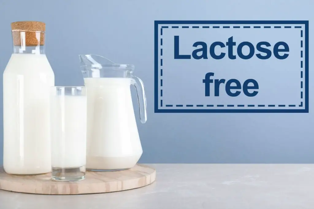Lactose free milk on a wooden table, one of the best drinks for IBS.