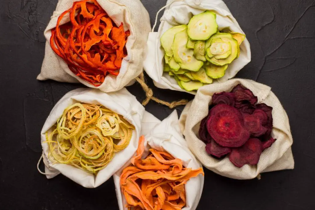 A variety of vegetables in sacks on a dark background, perfect for those looking for snacks for IBS.