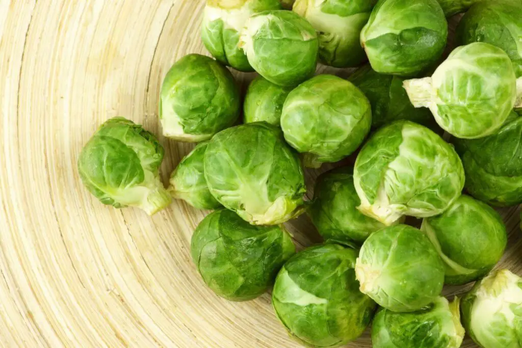 Brussels sprouts - cooked vegetables on a wooden plate.