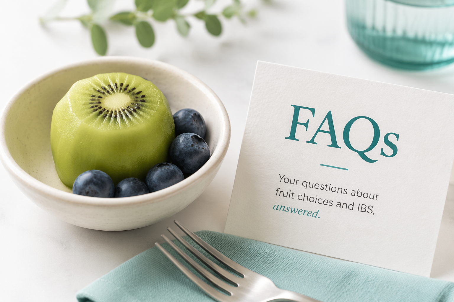 Bowl with kiwi and blueberries next to an FAQ card about fruits for IBS
