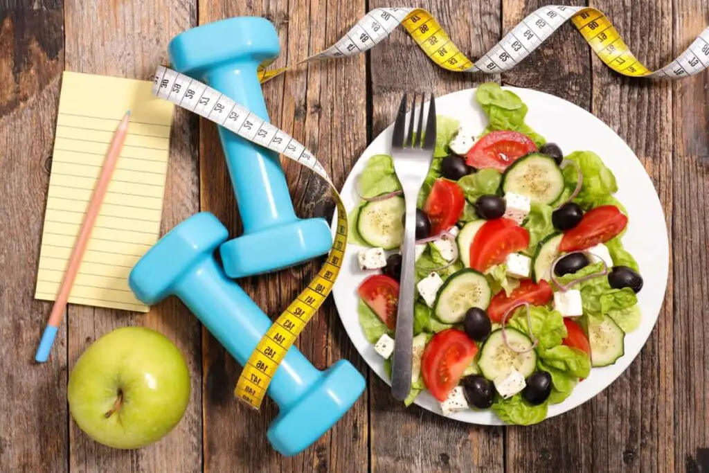 IBS-D foods, a plate of salad, apples and measuring tape.