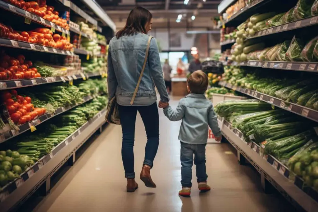 A mother and child navigating the grocery store aisle while looking for low fodmap diet options for IBS.