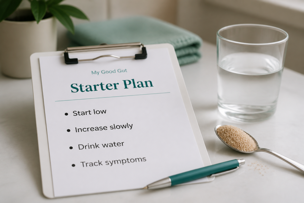 A clipboard with a paper titled "Starter Plan" lists: Start low, Increase slowly, Drink water, Track symptoms—your fiber guide for managing IBS. Nearby are a glass of water, a spoon with powder, a pen, and a folded towel.